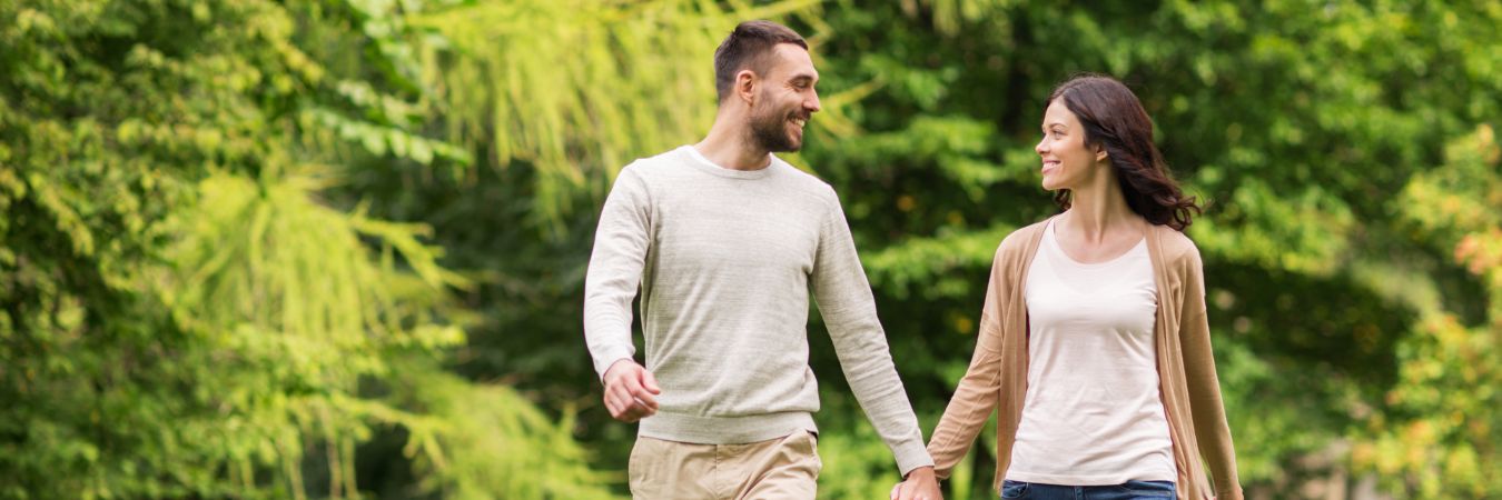  A couple walking hand in hand at a park during summer season enjoying life after rehab in Clark